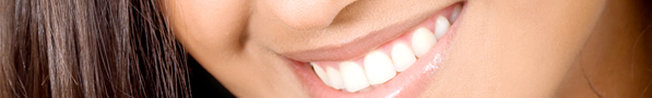 A woman smiling to show off her beautiful white teeth after receiving porcelain dental crowns at Lake Forest Dental Healthcare in Southern California